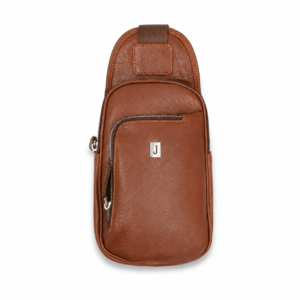 Brown leather sling bag with front zipper pocket, silver J logo plate, and minimalist crossbody design isolated on a clean white background.